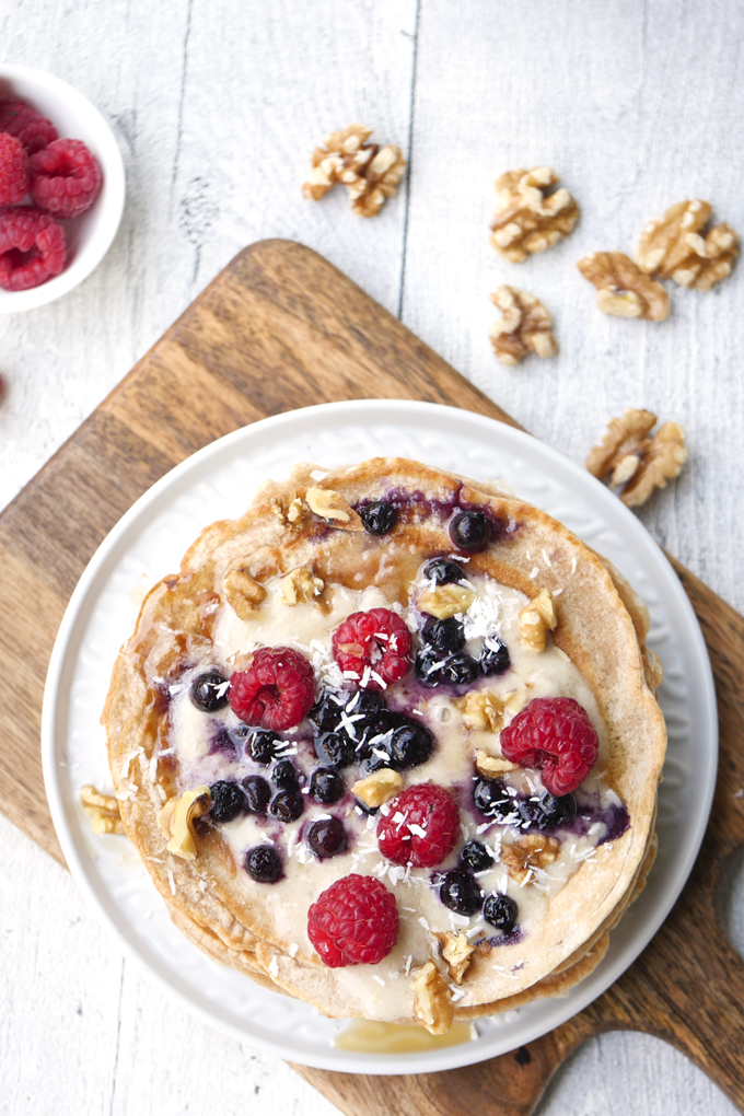 Sugar-free pancake cake with maple syrup, banana almond and fresh berries 
